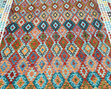 A vibrant, multicolored extra large room size tribal Afghan kilim rug featuring a geometric pattern.
