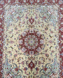 A Masterpiece Hand Knotted Persian Tabriz Rug with a floral medallion design in the center, featuring a mix of beige, light blue, grey, pink, terracotta and green tones.