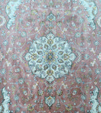 Decorative Persian rug with intricate floral patterns on a pinkish-brown background