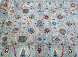 A multicolored handmade Afghan Sultani Chobi rug with a floral design and a geometric revival of Art Deco pattern, featuring a mix of gray, beige, light brown, green, gold, terracotta, maroon, and blue tones.