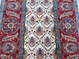 A detailed shot of a traditional hand-knotted Afghan Ziegler Chobi rug with a floral design, featuring beige, maroon, terracotta, blue, orange, and green tones at Persian rug warehouse WA in Perth
