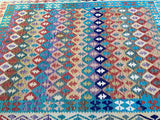 A multicolored geometric Boho patterned Afghan kilim rug.