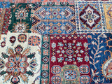 A multicolored hand-knotted rug featuring a floral pattern with a modern twist, above all in red, blue, and green shades.