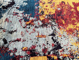 A Contemporary Afghan Gabbeh Rug featuring a mix of vibrant and muted colors on a cotton base.