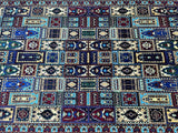 A hand-knotted Afghan rug featuring a geometric garden pattern in various colors, predominantly blue and red, on a white background.