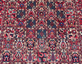 A vibrant, multicolored hand-knotted Persian Bakhtiari rug featuring geometric and floral patterns.