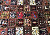 A multicolored, intricately designed Persian Bakhtiari rug with a floral and garden pattern.