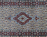 A certified hand knotted Persian hall runner with a geometric medallion Herati design in beige, burgundy, pink, blue, and orange tones.