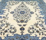 A hand-knotted Persian rug with a floral and geometric pattern in beige, blue, green, brown, and yellow tones.