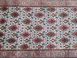 A vintage Persian Tabriz hall runner with a floral pattern in multiple colors including pink, brown, burgundy, and blue.