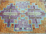 A geometric patterned tribal Gabbeh Afghan rug featuring purple, orange, beige, and blue tones.