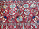 A vibrant, multicolored hand-knotted Afghan super Kazak rug featuring geometric patterns and a central medallion design.